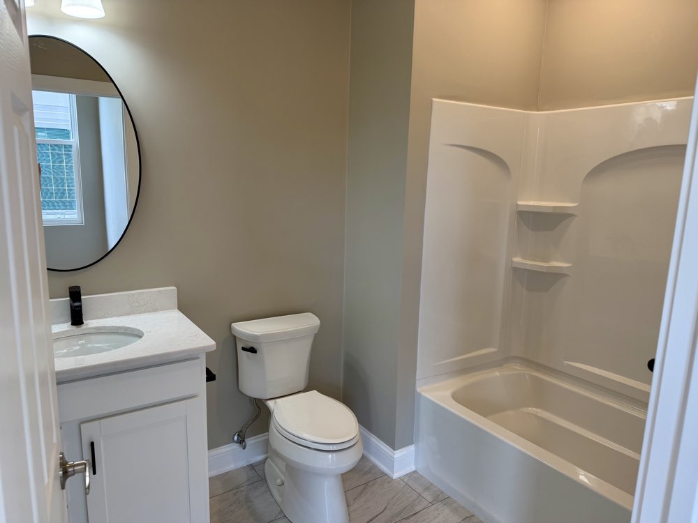 Apartment 1 bathroom with vanity and tub.