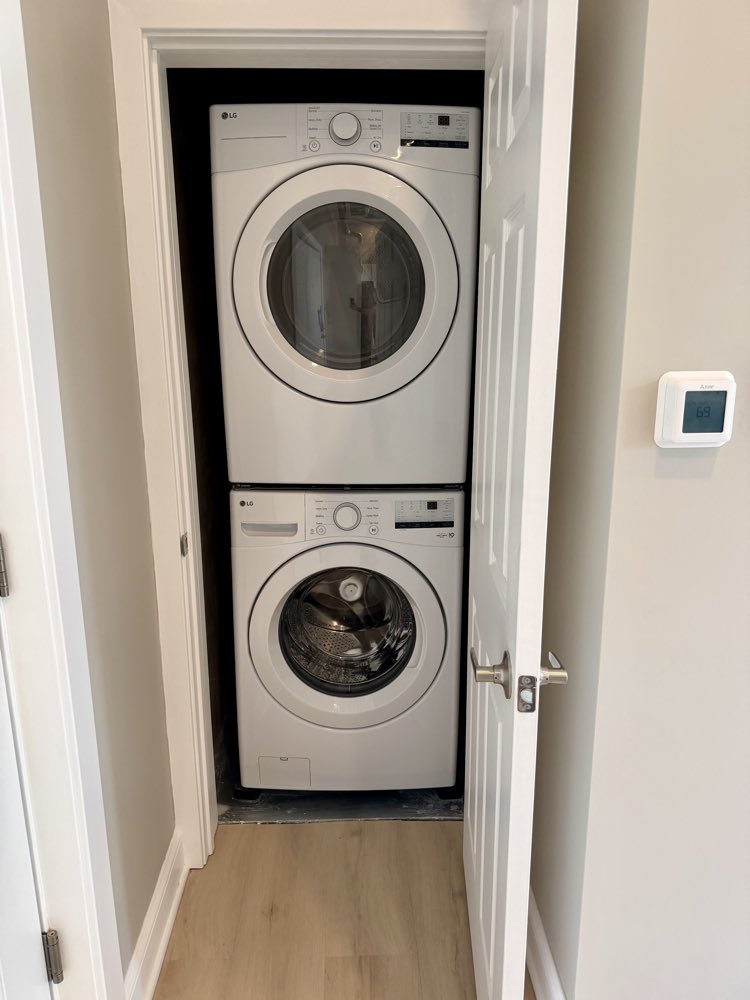 Apartment 1 stacked washer and dryer in a closet.