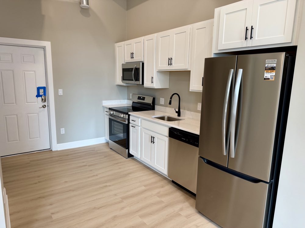 Apartment 2 — kitchen with stainless refrigerator and range.