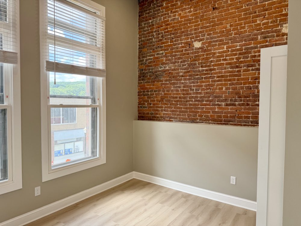 Apartment 2 bedroom with an exposed brick wall.