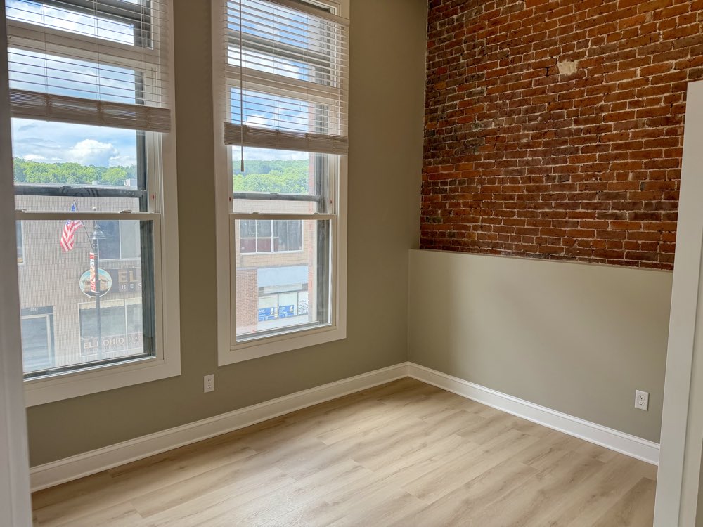 Apartment 2 bedroom windows against exposed brick.