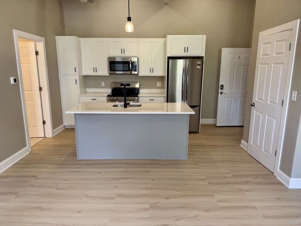 Apartment 3 — kitchen with a large quartz island.