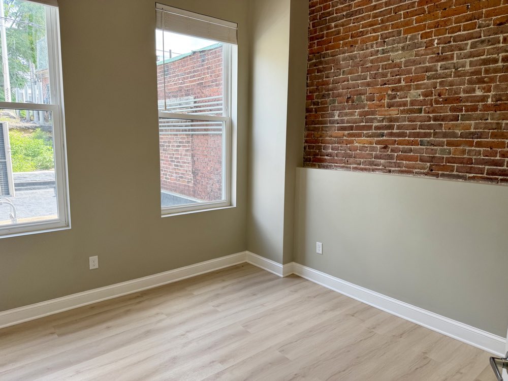 Apartment 3 bedroom with an exposed brick wall.