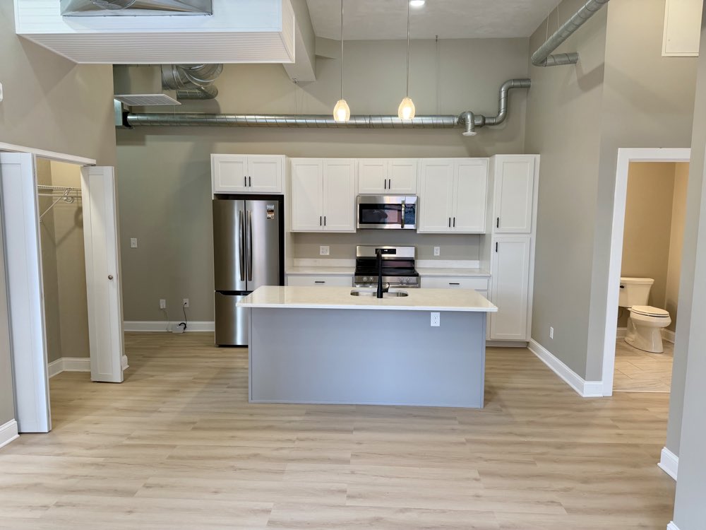 Apartment 4 — open kitchen with island and recessed lighting.