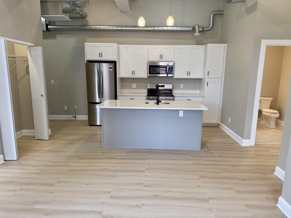 Apartment 4 kitchen with stainless range and island.