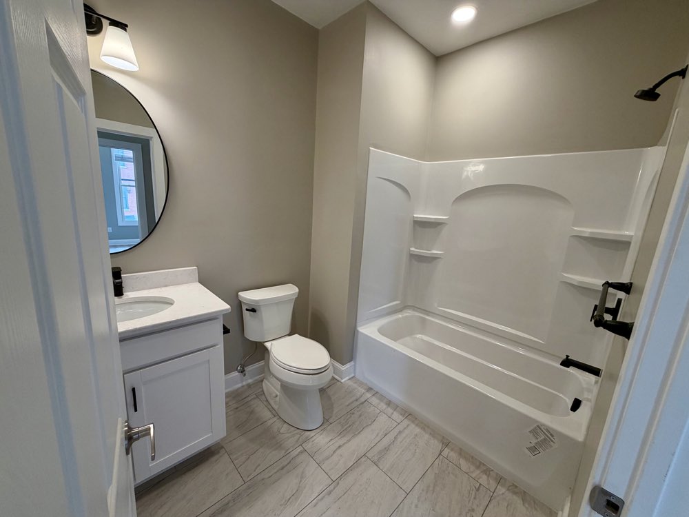 Apartment 4 bathroom with vanity and tub.