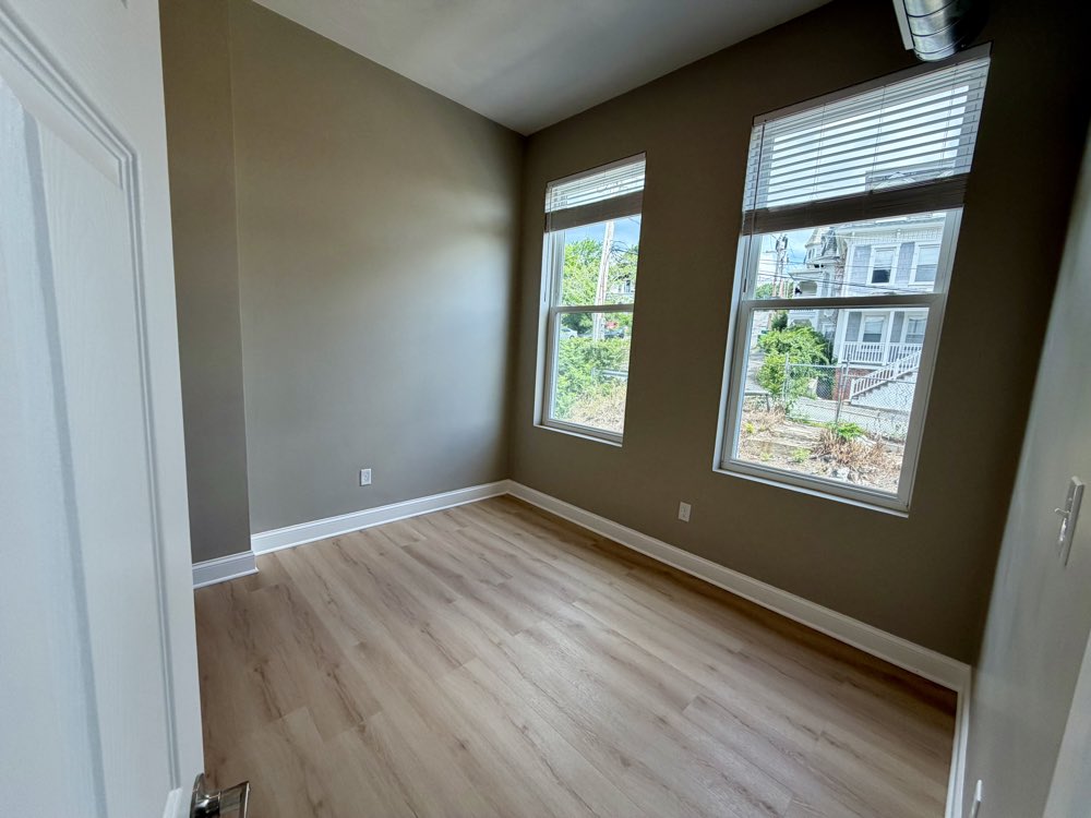 Apartment 5 bedroom with windows on two walls.
