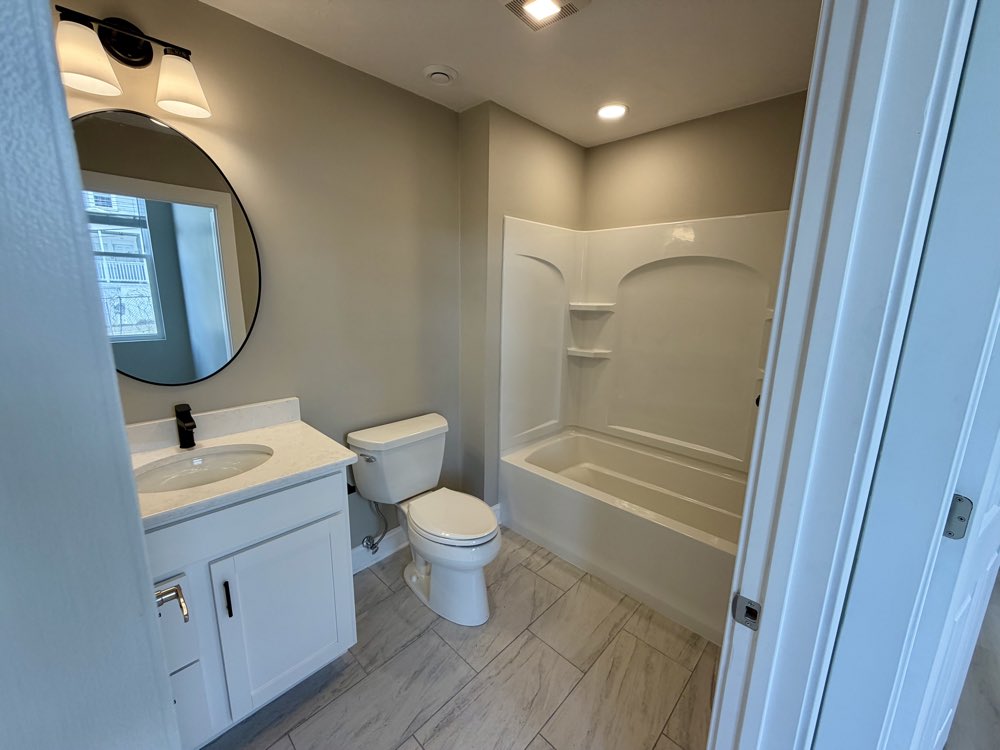 Apartment 5 bathroom vanity and tub.
