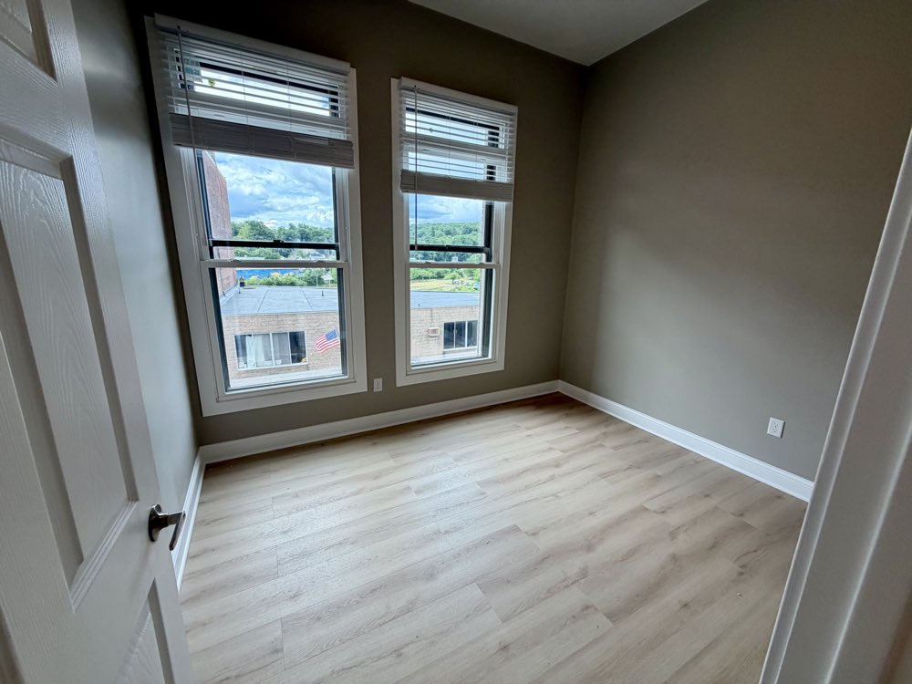 Apartment 6 living area with a bank of windows.