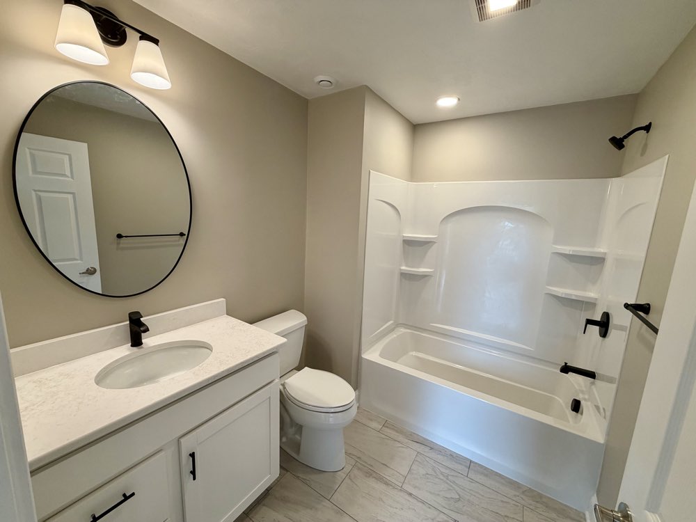 Apartment 6 bathroom vanity and tub.