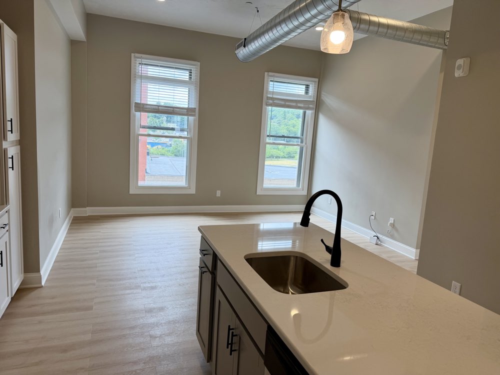 Apartment 6 island with undermount sink and matte black faucet.