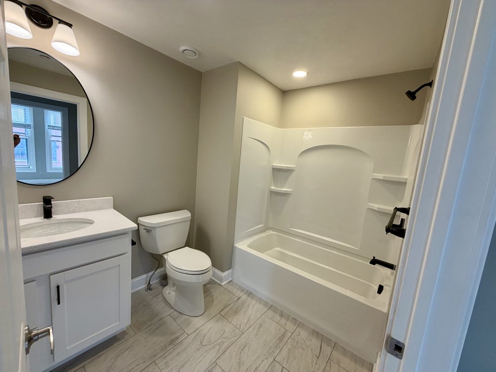 Apartment 8 bathroom with vanity and tub.