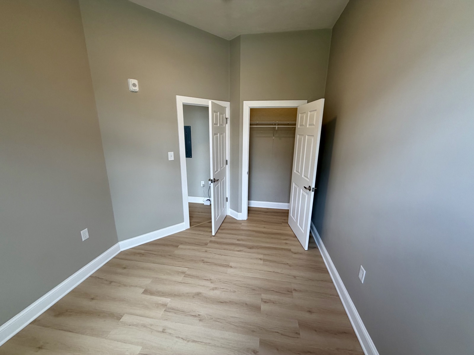Bedroom with closet and doorway to the living area.